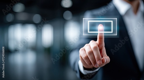 Businessman Interacting with Holographic Interface in Dark Blue Suit Against Blurred Office Environment