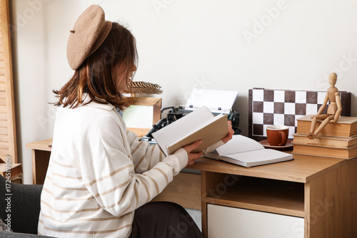 Female author with book sit...