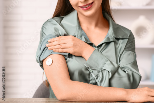 Woman with glucose sensor i...