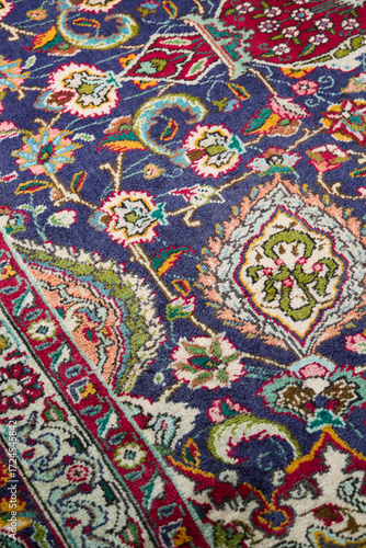 Detail of persian carpet macro: floral blue and red pattern texture
