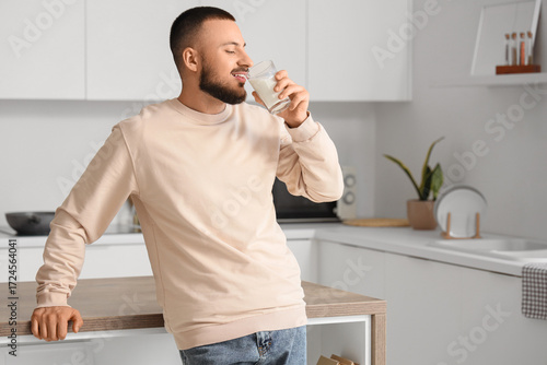 Handsome man drinking milk ...