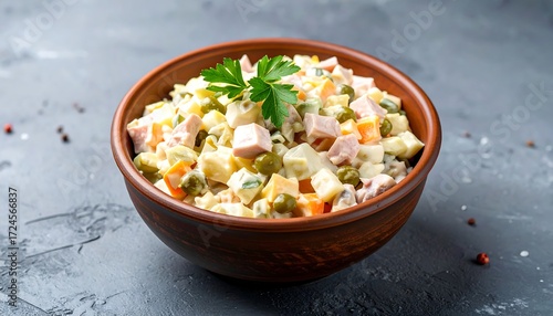 A hearty salad bowl, filled with a colorful, creamy mixture