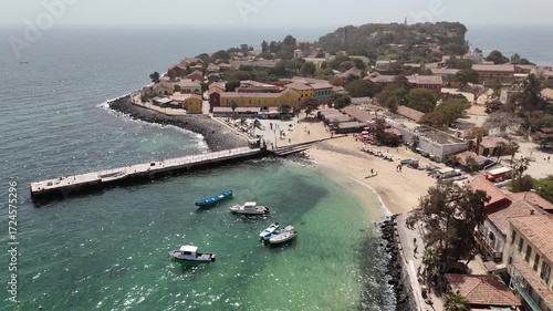 Wallpaper Mural Aerial sweep by drone over Gorée Island coast, with sandy beach, colonial architecture and turquoise waters, historic African UNESCO World Heritage Torontodigital.ca