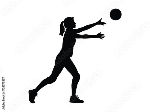 Silhouette of a female volleyball player serving the ball
