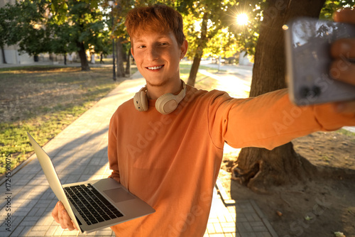 Teenage boy with laptop and...
