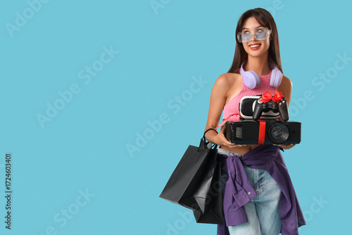 Young woman with gadgets an...