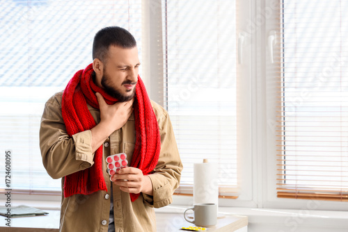 Ill young man with throat l...
