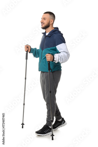 Sporty man with walking pol...
