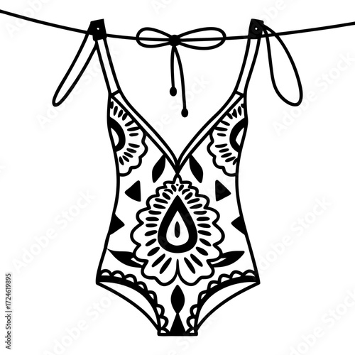 Swimsuit with floral pattern hanging on a clothesline against white background  