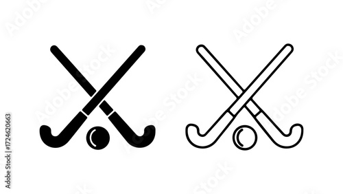 Two hockey sticks crossed with a hockey ball in between them in black and white.