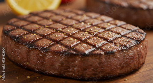 Close-up captures a succulent, perfectly grilled steak seasoned with aromatic herbs, exhibiting a mouthwatering texture and inviting aroma, resting on a wooden board, evokes feelings of indulgence.