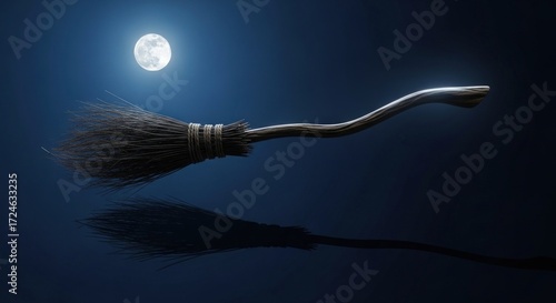 Witch's broom flying across the night sky with a full moon shining above
