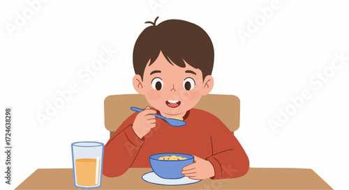 A happy young boy enjoys a nutritious bowl of cereal and a glass of juice for a healthy morning breakfast routine