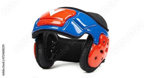 Blue and red protective wrestling headgear with a white arrow design sits on a white surface
