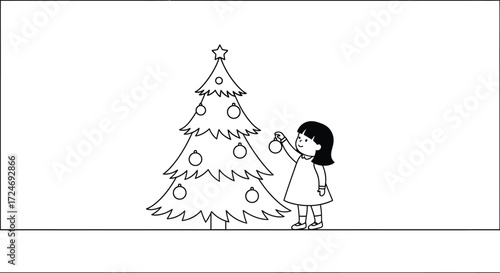 Young child happily decorating a Christmas tree with ornaments