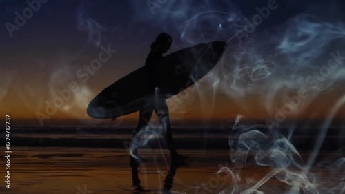 Sunset inspiring female surfer carrying surfboard entering waves with swirling smoke for travel