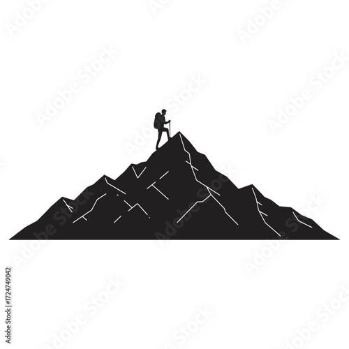 Silhouette of a lone hiker standing on a mountain peak
