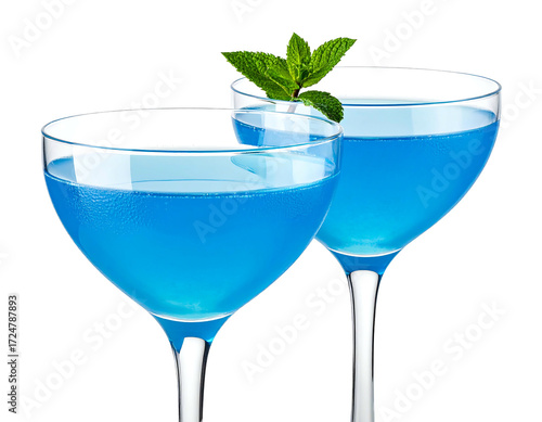 Two vibrant blue cocktails in stemmed glasses, garnished with mint