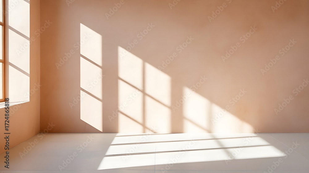 Obraz premium Sunlight streams through window into a peach-colored room.