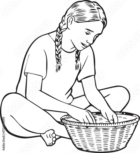 Young girl with braided hair sitting and sorting items in a woven basket