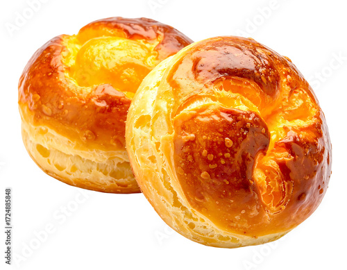 Two golden-brown, round pastries, slightly overlapping, with a glossy,  cheesy topping