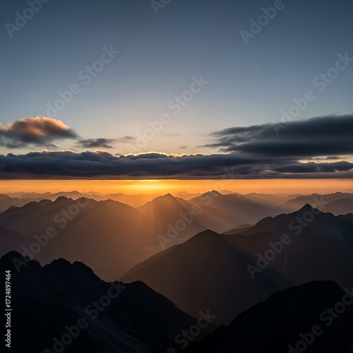 Wallpaper Mural Sunrise illuminates a vast mountain range, casting golden light through layers of clouds. Torontodigital.ca