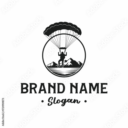 A circular logo design featuring a parachutist or skydiver landing near mountains and a body of water.
