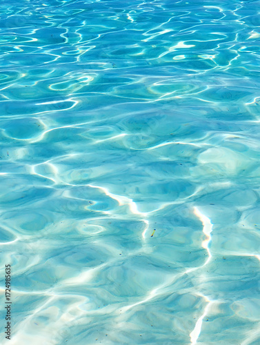 The particles vary in size, with some appearing as tiny specks and others as larger, glowing orbs, giving a sense of depth and movement. The light interacts with the particles, creating subtle bokeh e