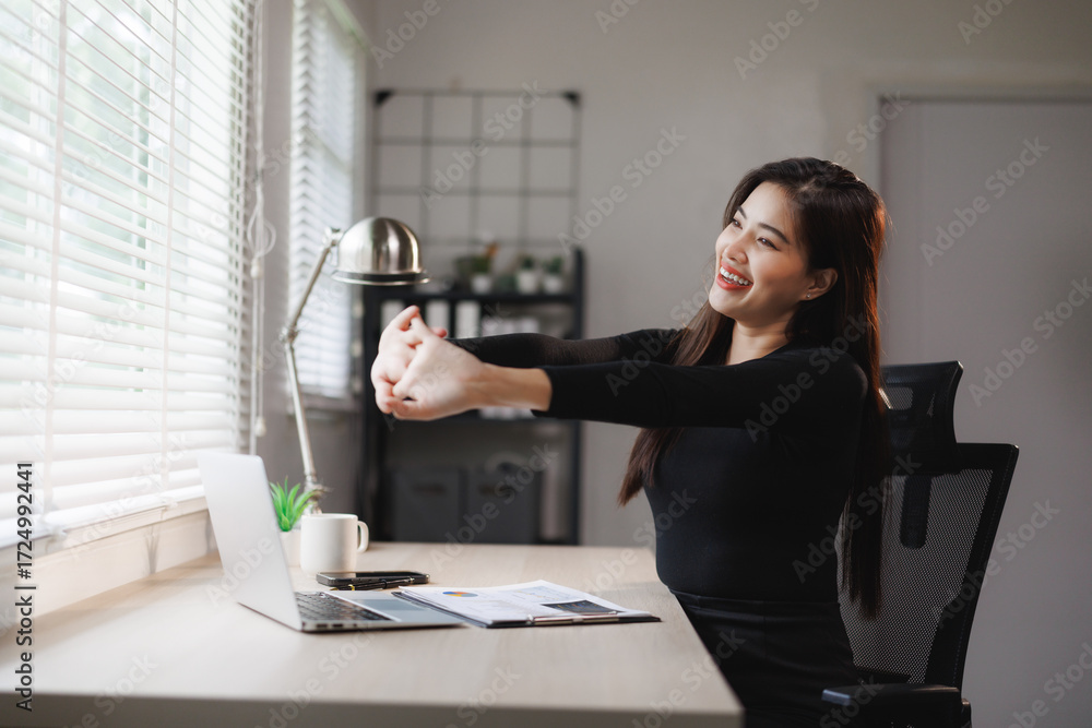 Εκτύπωση καμβά Businesswoman stretching arms at office desk, preventing occupational overuse sy
