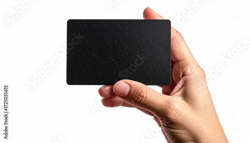 A hand holds a blank, black, rectangular card with a subtly textured surface against a white background