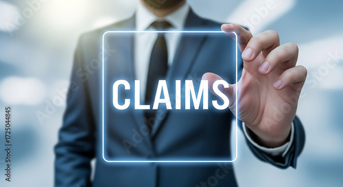 Businessperson's hand pressing the word CLAIMS on a transparent screen for insurance concepts