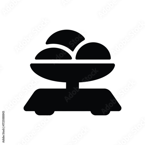 Black Icon Depicting an OldFashioned Scale with Three Rounded Objects on the Weighing Plate