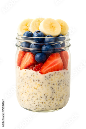 Close up of overnight oats in a glass jar with sliced strawberries, blueberries and banana slices on a transparent background. Healthy and nutritious breakfast.