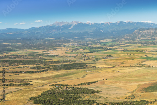 Scenic view of a valley and surrounding natural landscape in Colorado, featuring rugged terrain, mountains and wilderness, perfect for travel and nature concepts.