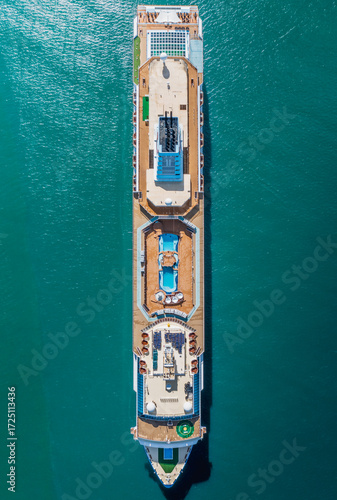 Torquay, United Kingdom - 24 May 2021: Aerial view of a majestic cruise ship cutting through the turquoise waters, its decks a playground of pools and sunbeds.