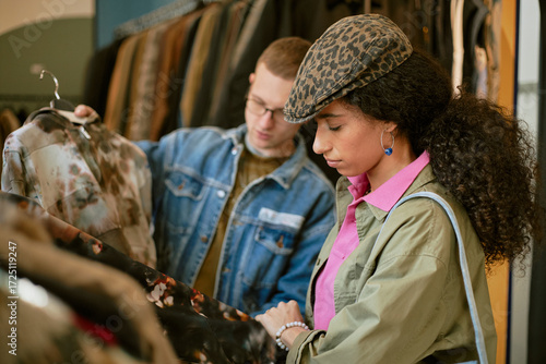 People shopping for vintage fashion in a thrift store