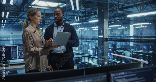 Fotografia Working Together in a High-Tech Data Center, Black Male IT Specialist and Female