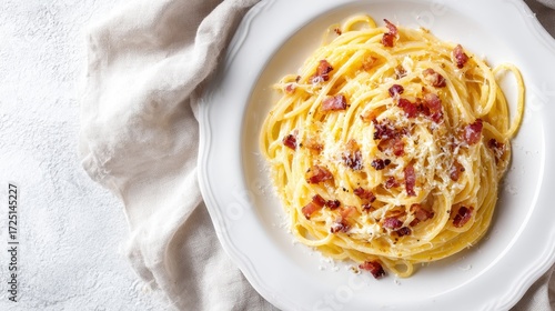 Classic Spaghetti Carbonara: Creamy Italian Pasta Dish Topped with Crispy Bacon, Egg Yolk, and Grated Cheese on a White Plate.