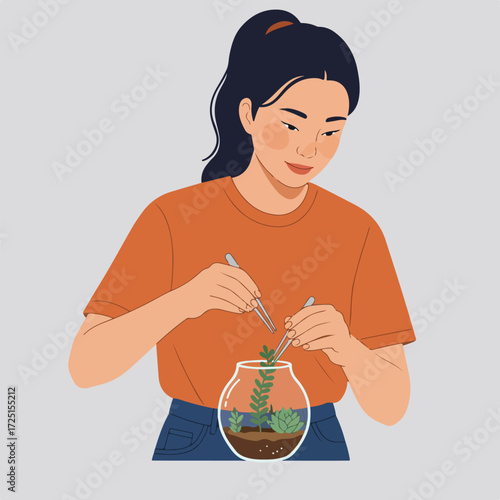 Woman creates mini terrarium in glass bowl with succulents using tweezers