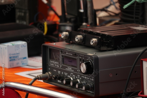 Amateur radio transceiver sits on a table at a ham radio convention, showcasing communication technology and hobbyist enthusiasm.