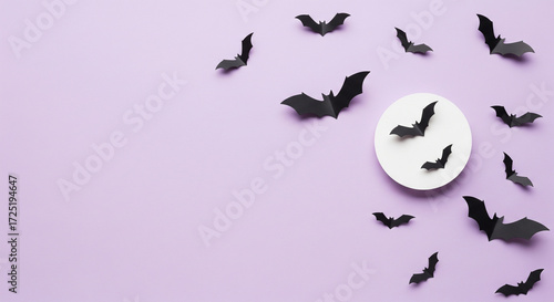 Clean halloween design, pastel purple background, flat lay with black paper bats flying and white full moon circle, minimalist aesthetic with large empty copy space