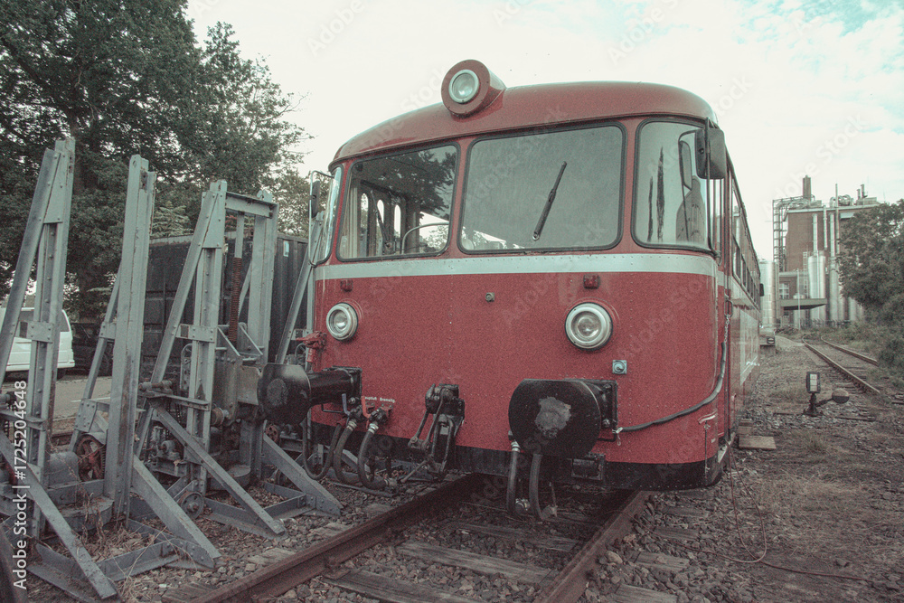 Naklejka premium Front view of classic red railbus parked on railway tracks