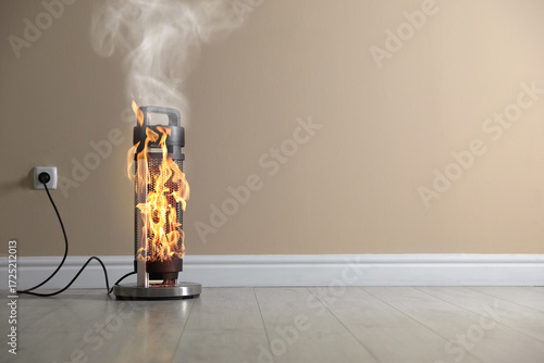 Fototapeta Naklejka Na Ścianę i Meble -  Burning heater in room, flames all over device. Do not leave unattended. Dangerous accident