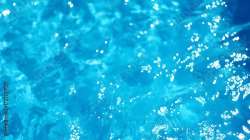 A vibrant, close-up view of rippling, turquoise water, featuring subtle light reflections and sparkling bubbles.