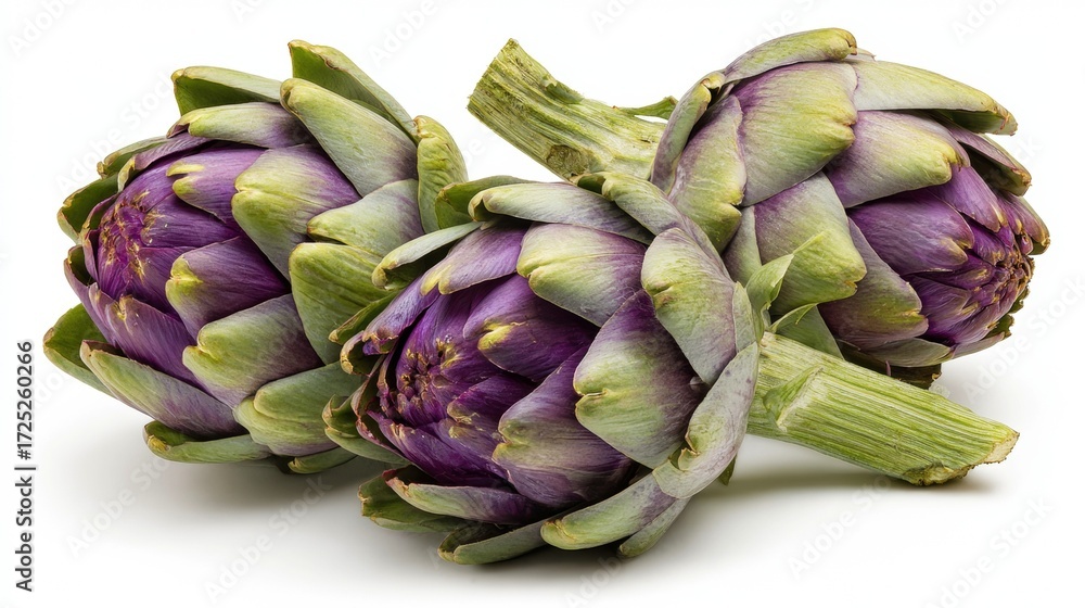 Obraz premium Fresh purple artichokes with vibrant green leaves on white background, showcasing natural organic vegetables for healthy cooking and Mediterranean cuisine
