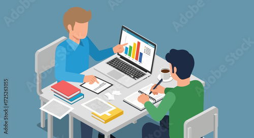 Two people are sitting at a table, one pointing at a laptop screen with a graph, the other writing.