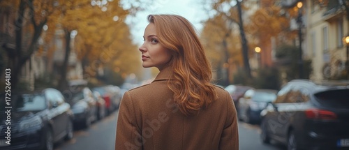 Autumn Stroll: A Woman's Serene Walk Through a City Street