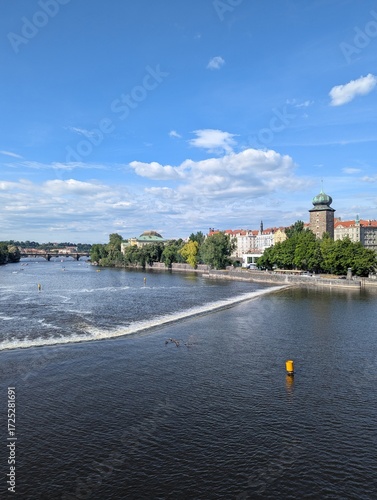 Prague Vltava River Weir with Green-Domed Tower and Historic Skyline