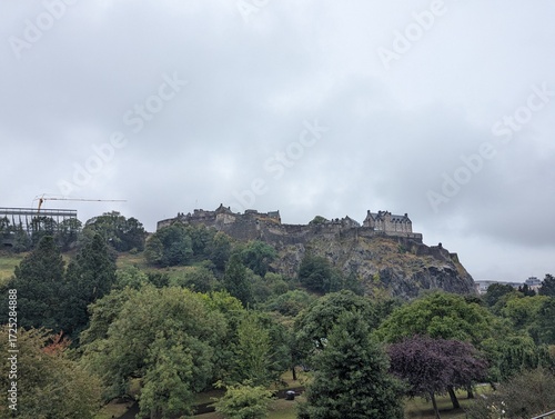 Edinburgh Castle with maintenance crane atop Castle Rock under overcast sky in Edinburgh Scotland