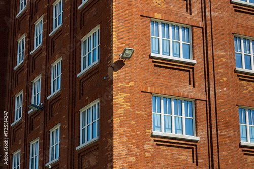 Bild auf Leinwand facade of an old building, red brick building with white windows